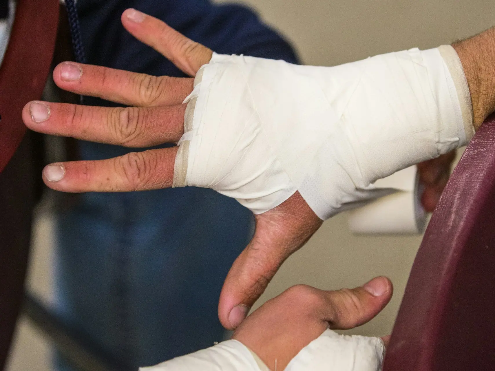 person in white gloves holding persons hand